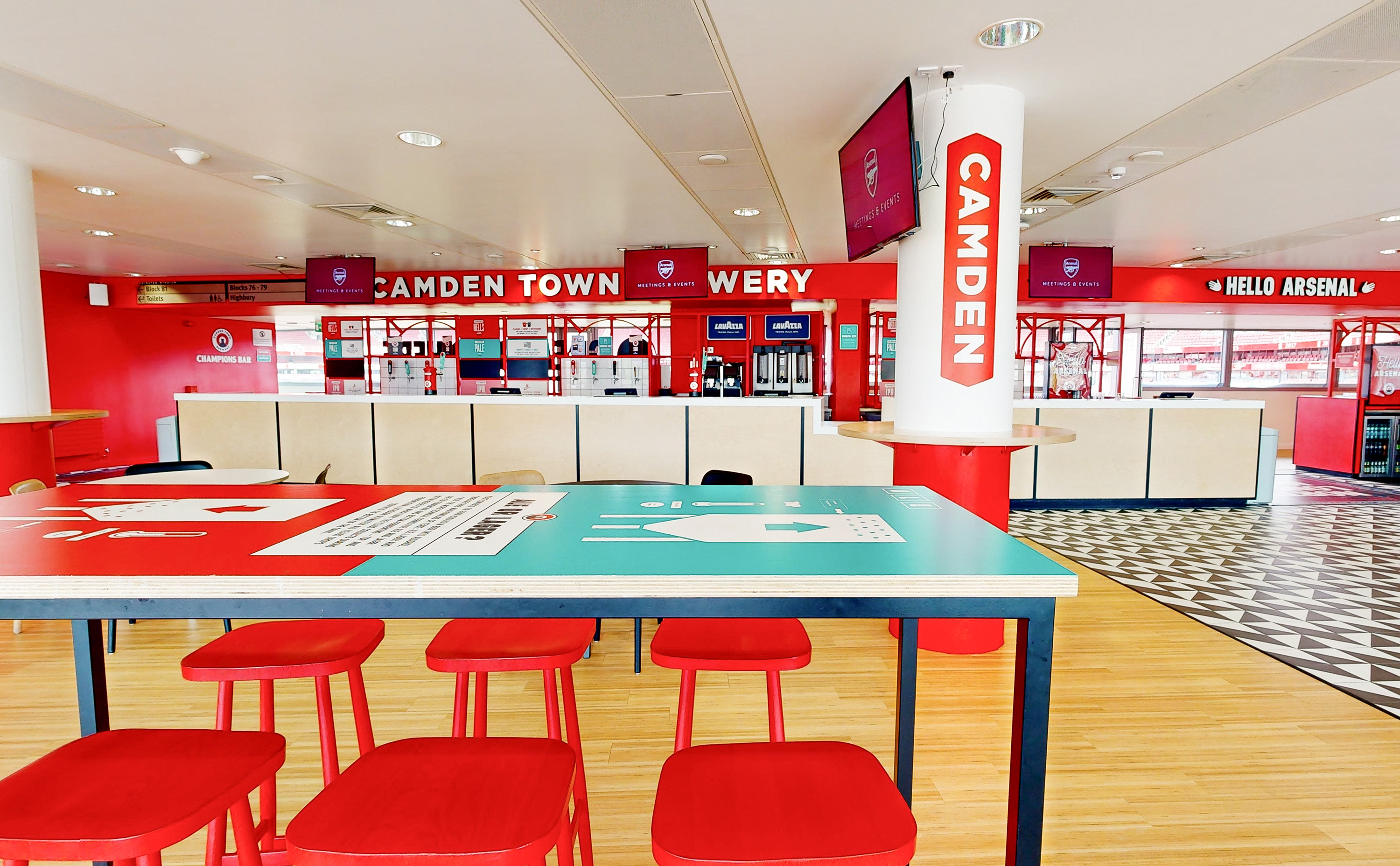 Champions event space at Arsenal FC, featuring bold red decor for meetings and gatherings.