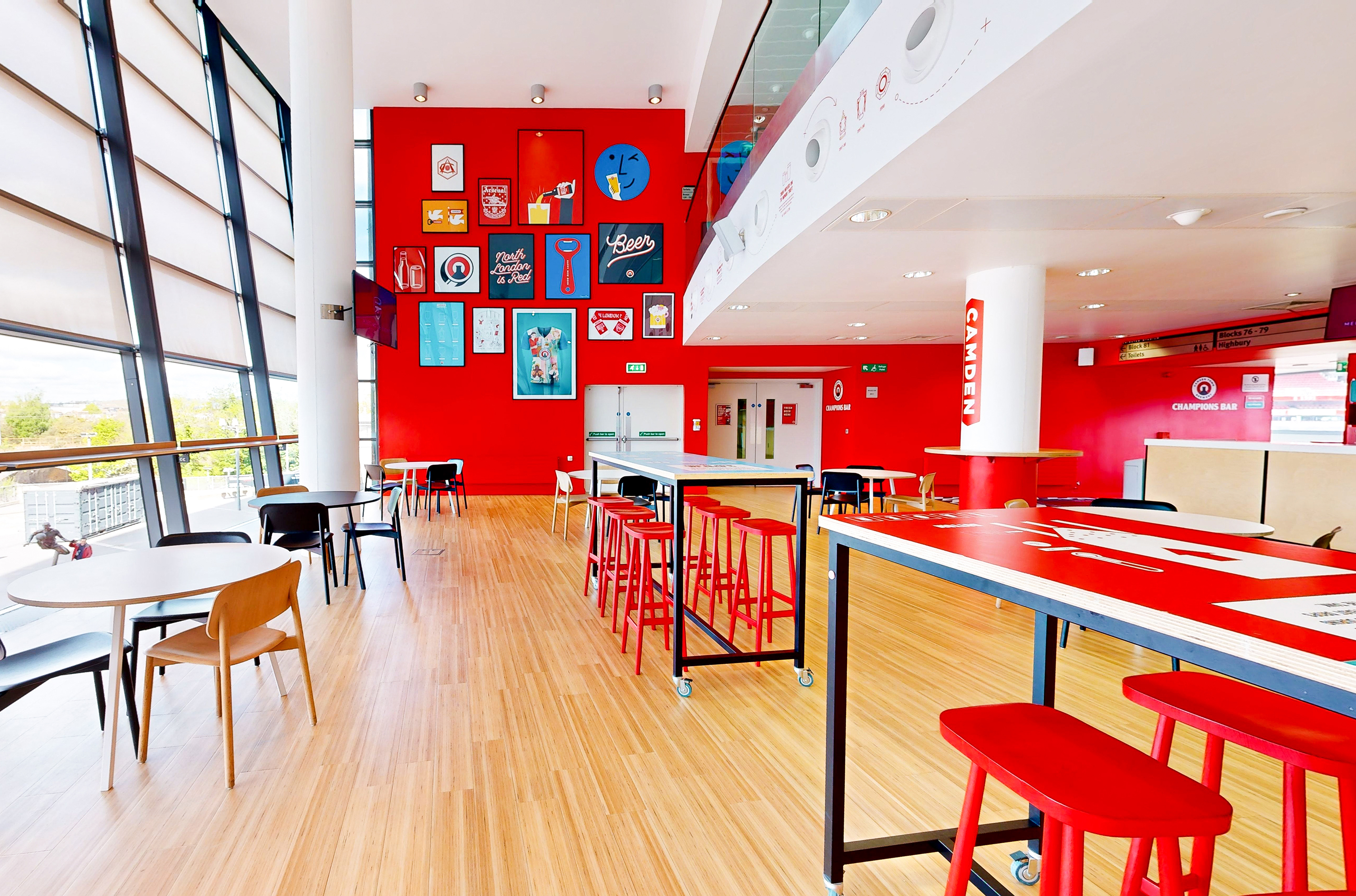 Champions at Arsenal FC: modern event space with red walls for networking and meetings.