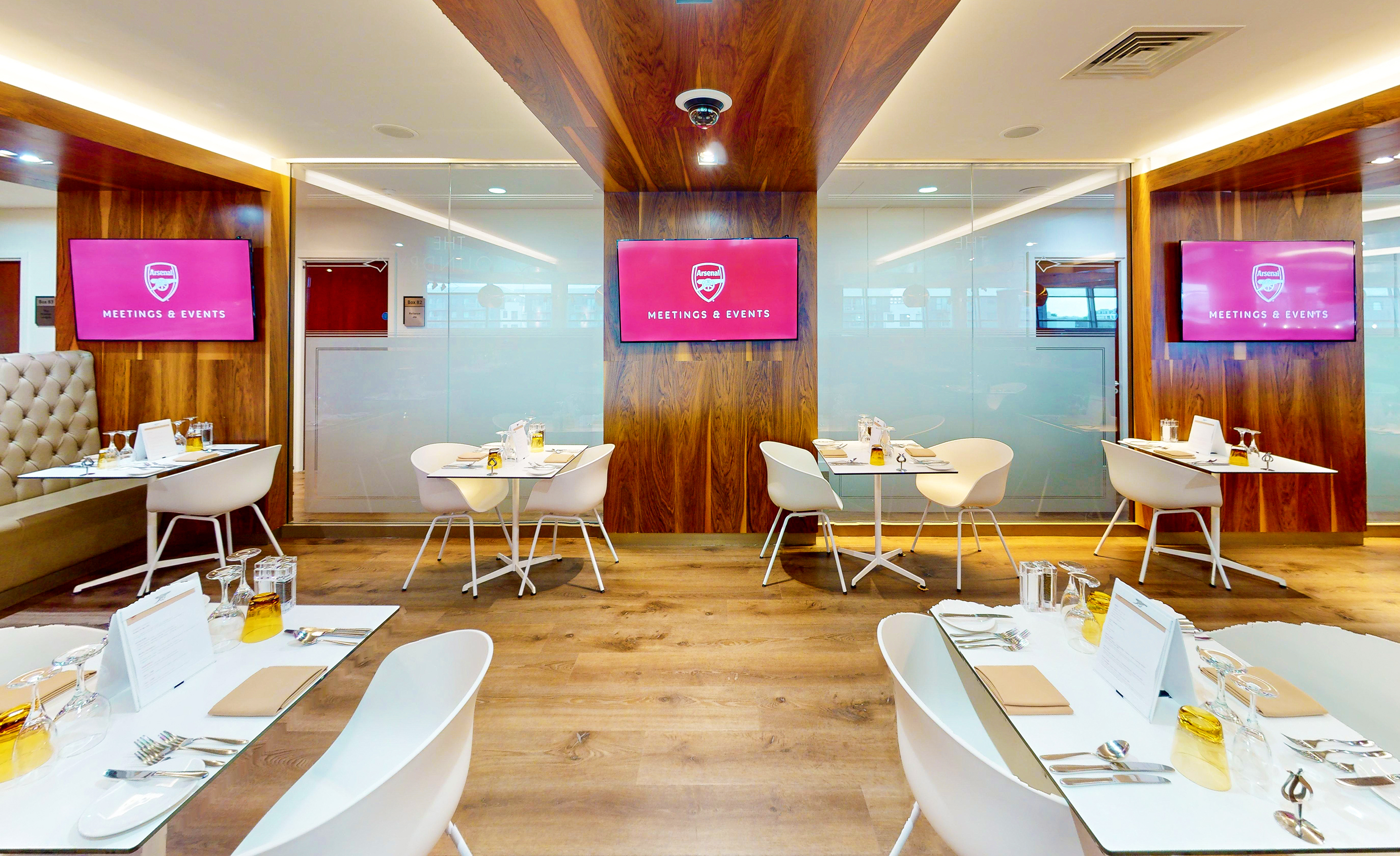 Modern meeting space at Arsenal's Emirates Stadium with sleek furniture for events.