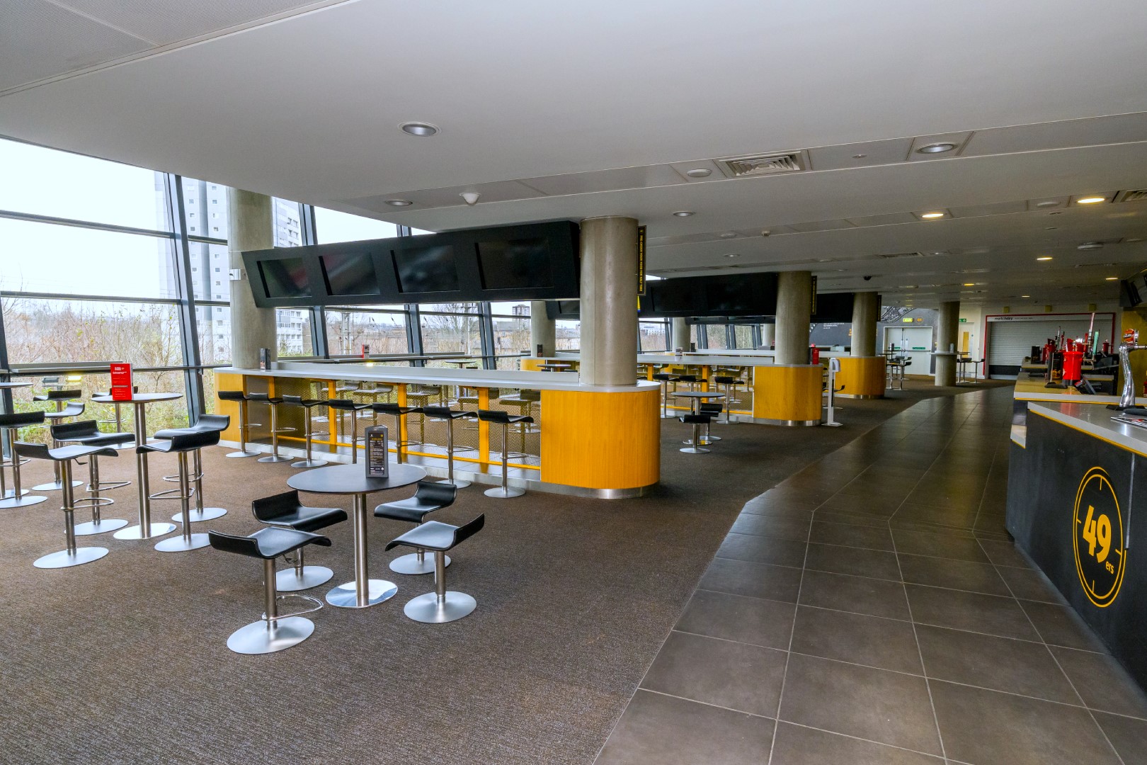 49ers event at Emirates Stadium with modern furniture and natural light for networking.
