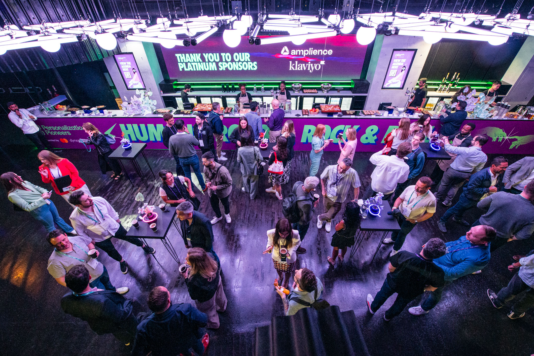 Vibrant networking event at Ministry of Sound with stylish bar and sponsor branding.