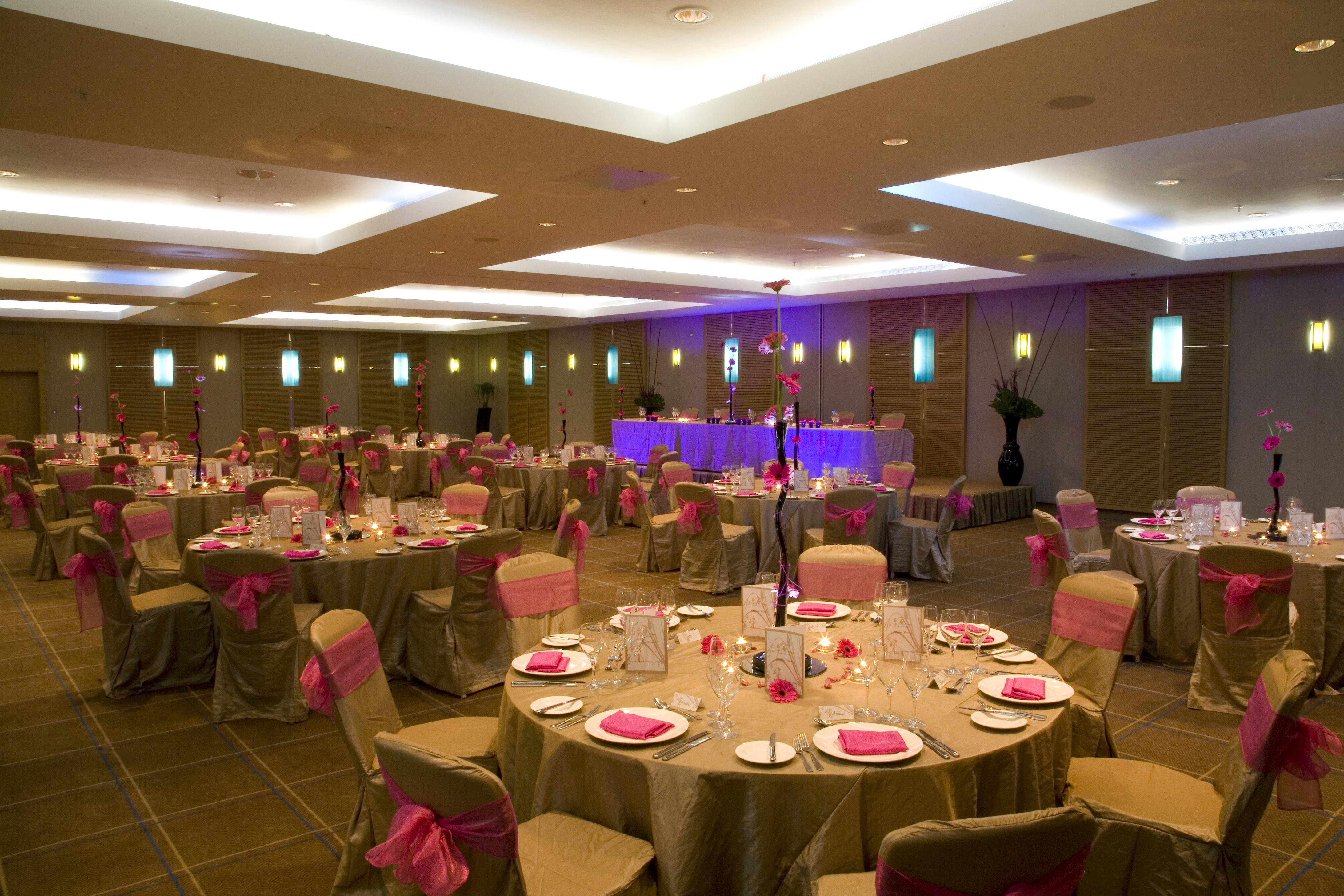 Quayside suite banquet hall with gold tablecloths, ideal for weddings and corporate events.