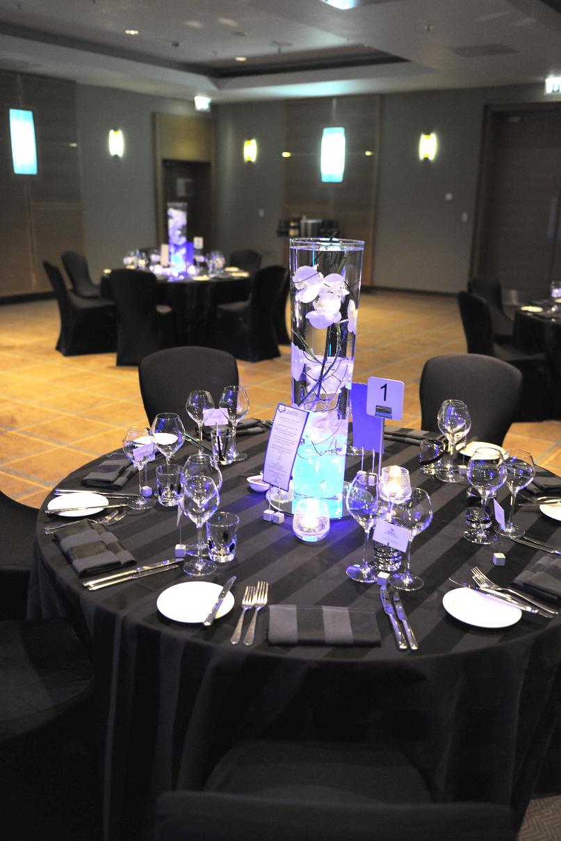 Quayside suite at Hilton London: elegant event setup with black linens and modern centerpieces.
