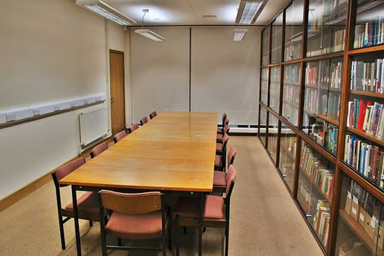 Liverpool Quaker Meeting House library with wooden table, ideal for meetings and workshops.