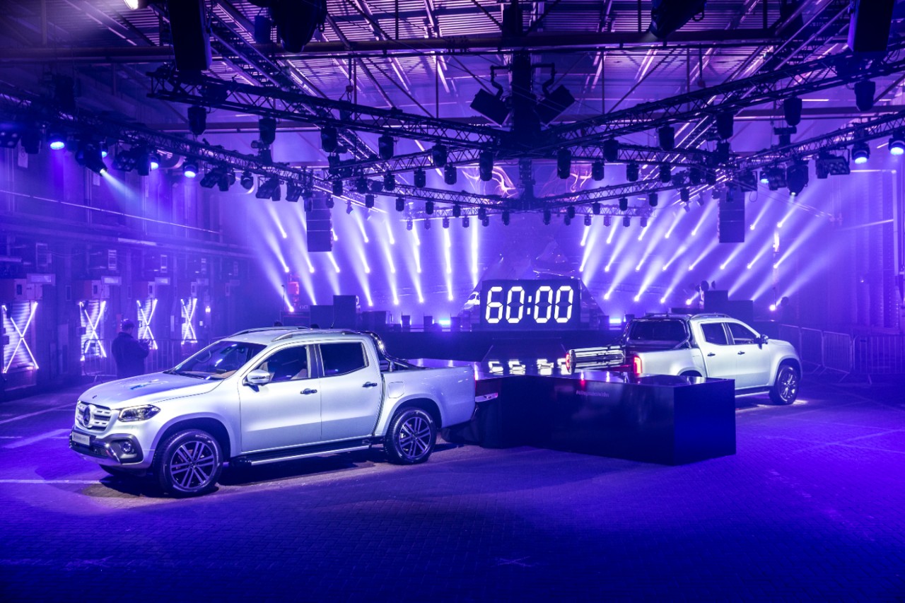 Dynamic event setup with pickup trucks and countdown timer at Printworks London.
