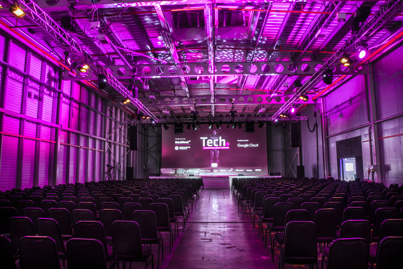 Event space at Reel Storage, Printworks London, with purple lighting for a tech conference.