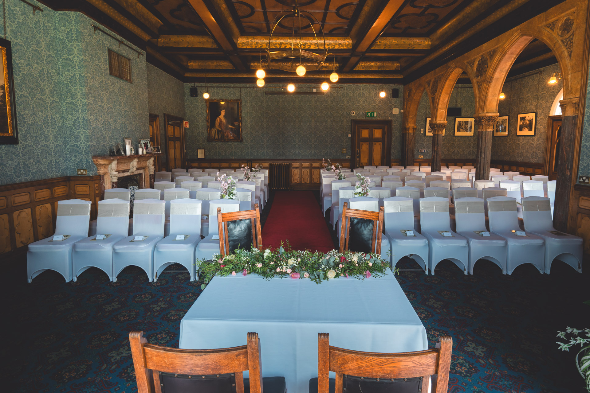 Elegant event space at Highbury Hall with blue wallpaper, ideal for ceremonies and meetings.
