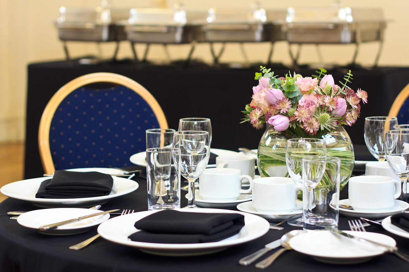 Presidential Suite dining table with floral centerpiece for corporate events at The London Irish Centre.