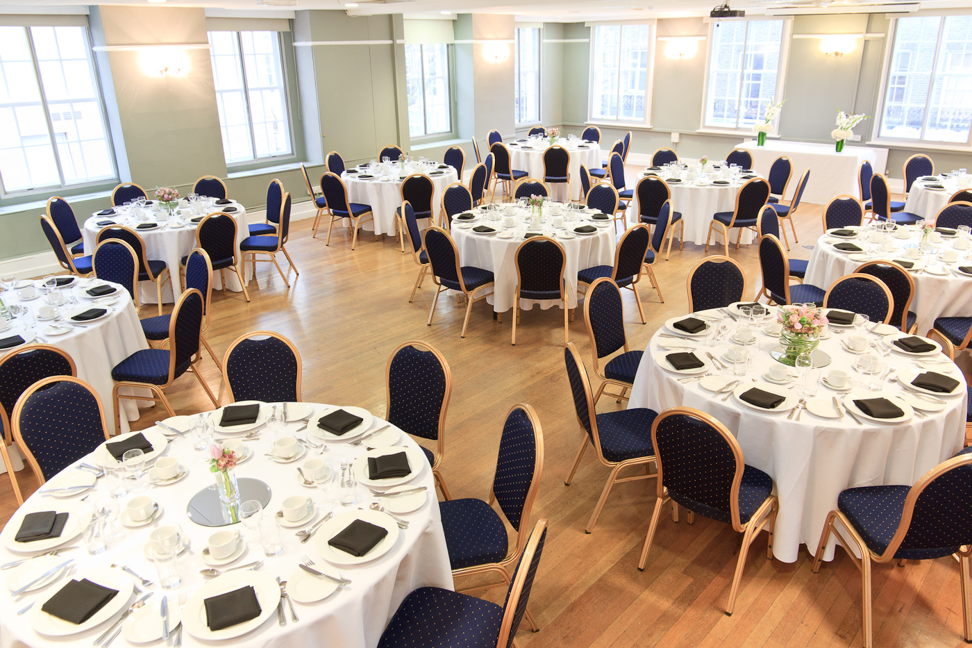 Presidential Suite banquet hall with elegant tables for events and networking.