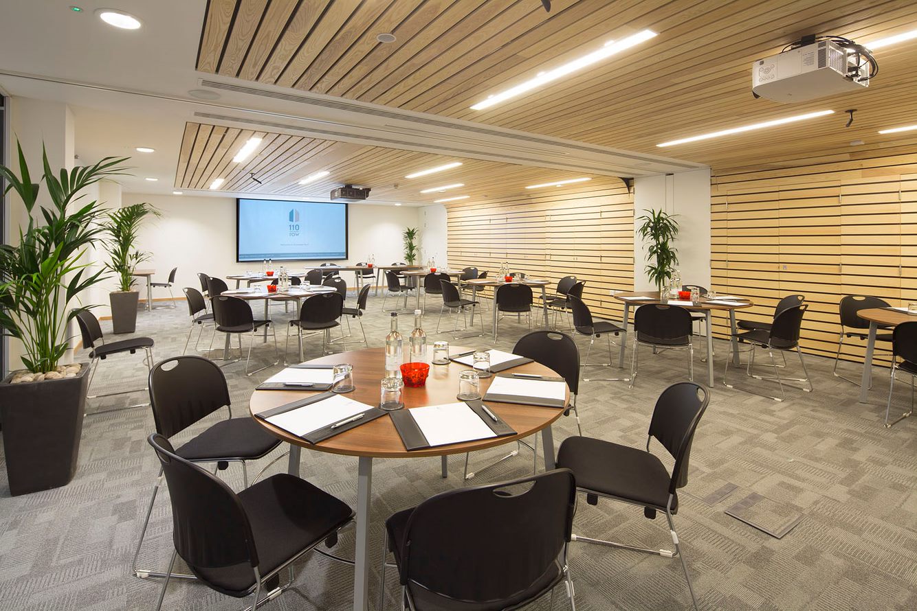 Nightingale Suite meeting space with round tables, ideal for workshops and presentations.