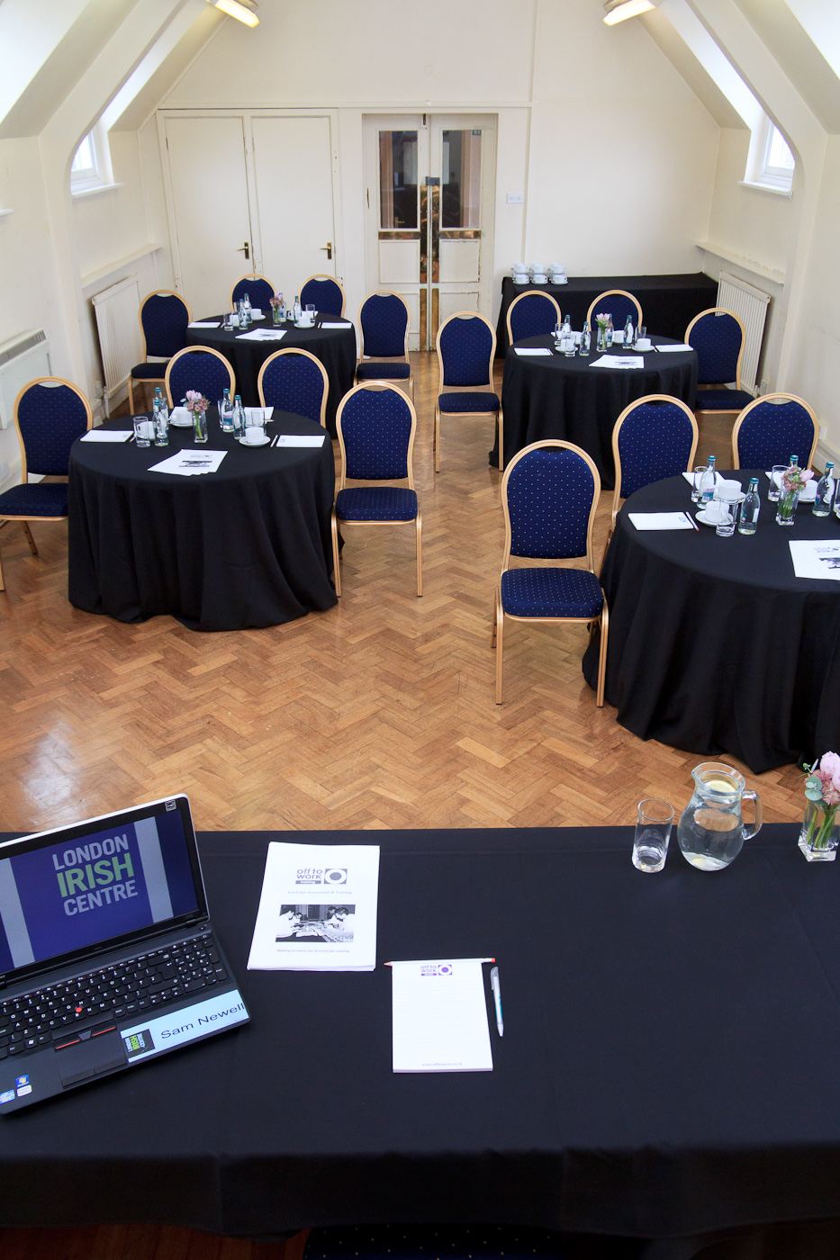 Chapel Suite at The London Irish Centre, elegant meeting space with round tables and floral decor.