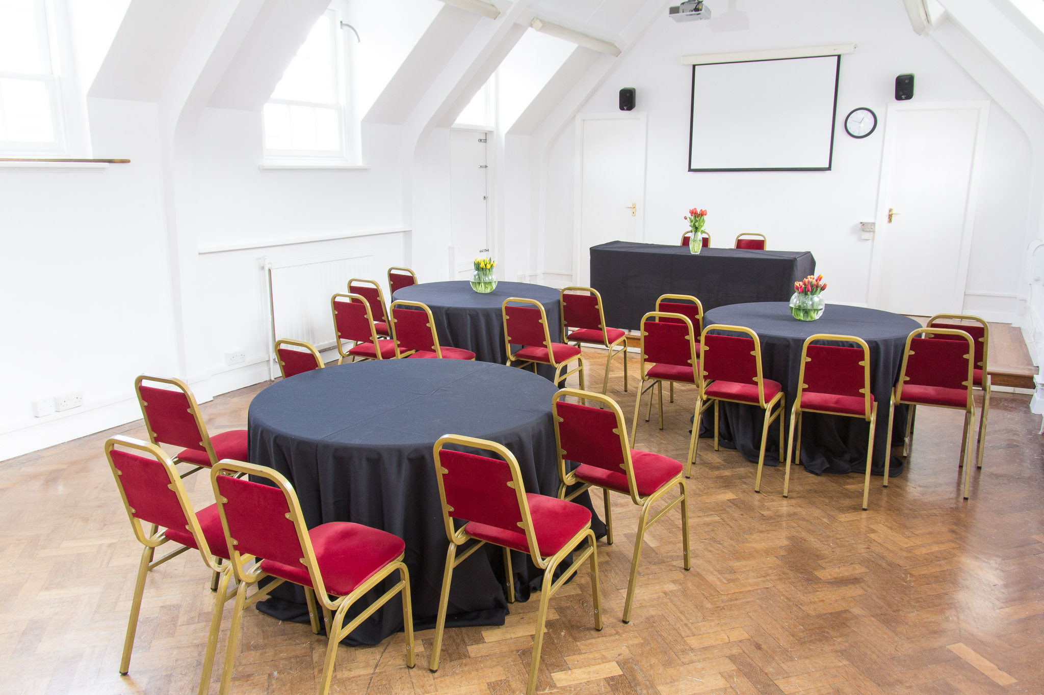 Chapel Suite at The London Irish Centre, ideal for workshops with round tables and projector.