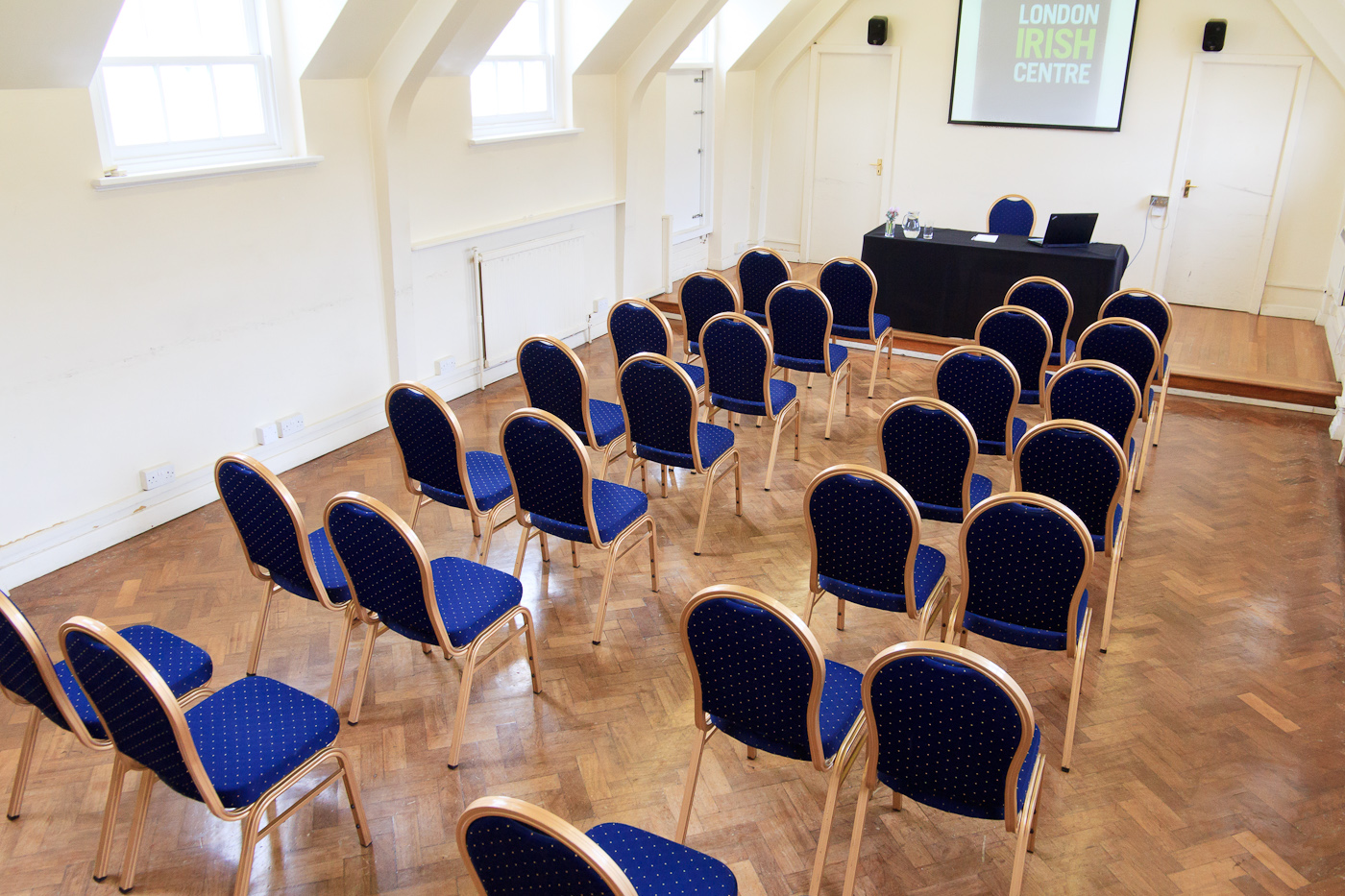Chapel Suite at The London Irish Centre, blue chairs for workshops and seminars.