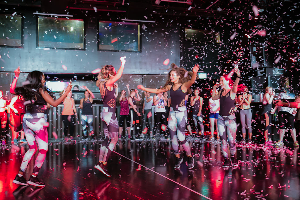 Vibrant group fitness event at The Box, Ministry of Sound with confetti celebration.