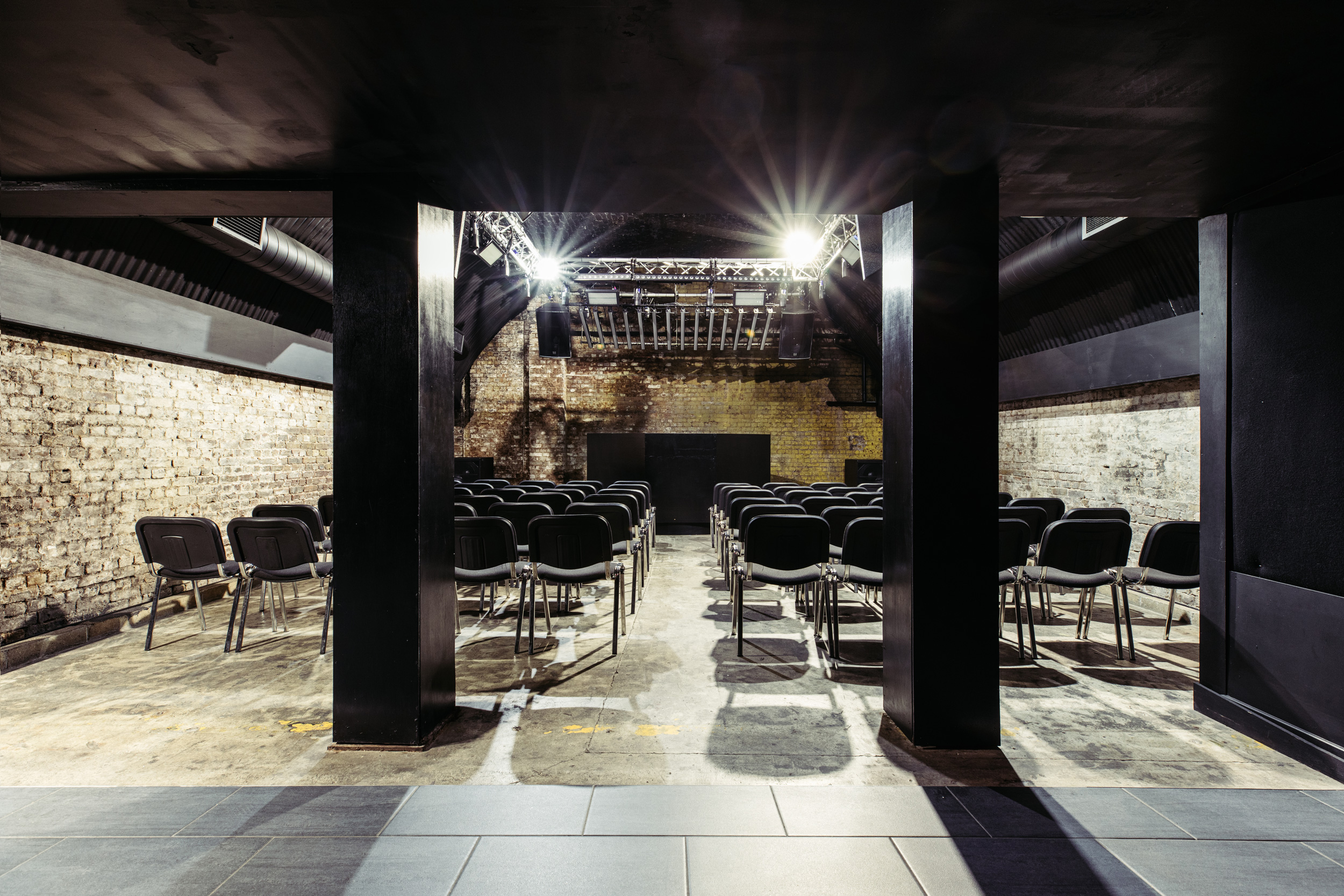 The Baby Box at Ministry of Sound: minimalist event space with black chairs and exposed brick.