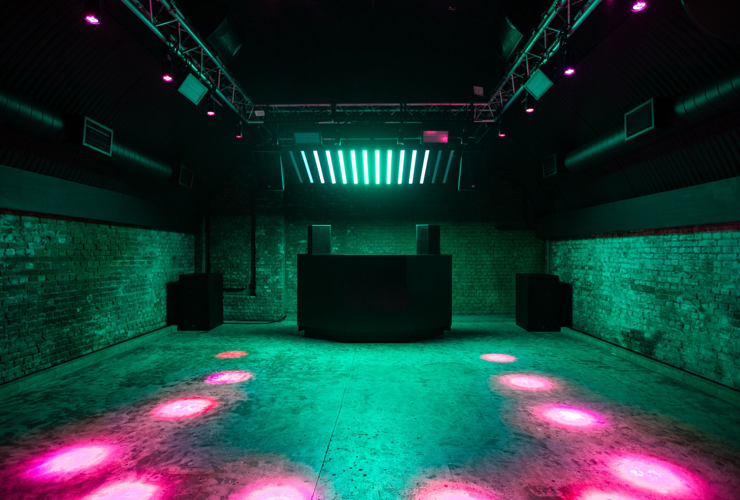 Modern event space at Ministry of Sound with vibrant lighting and DJ booth.