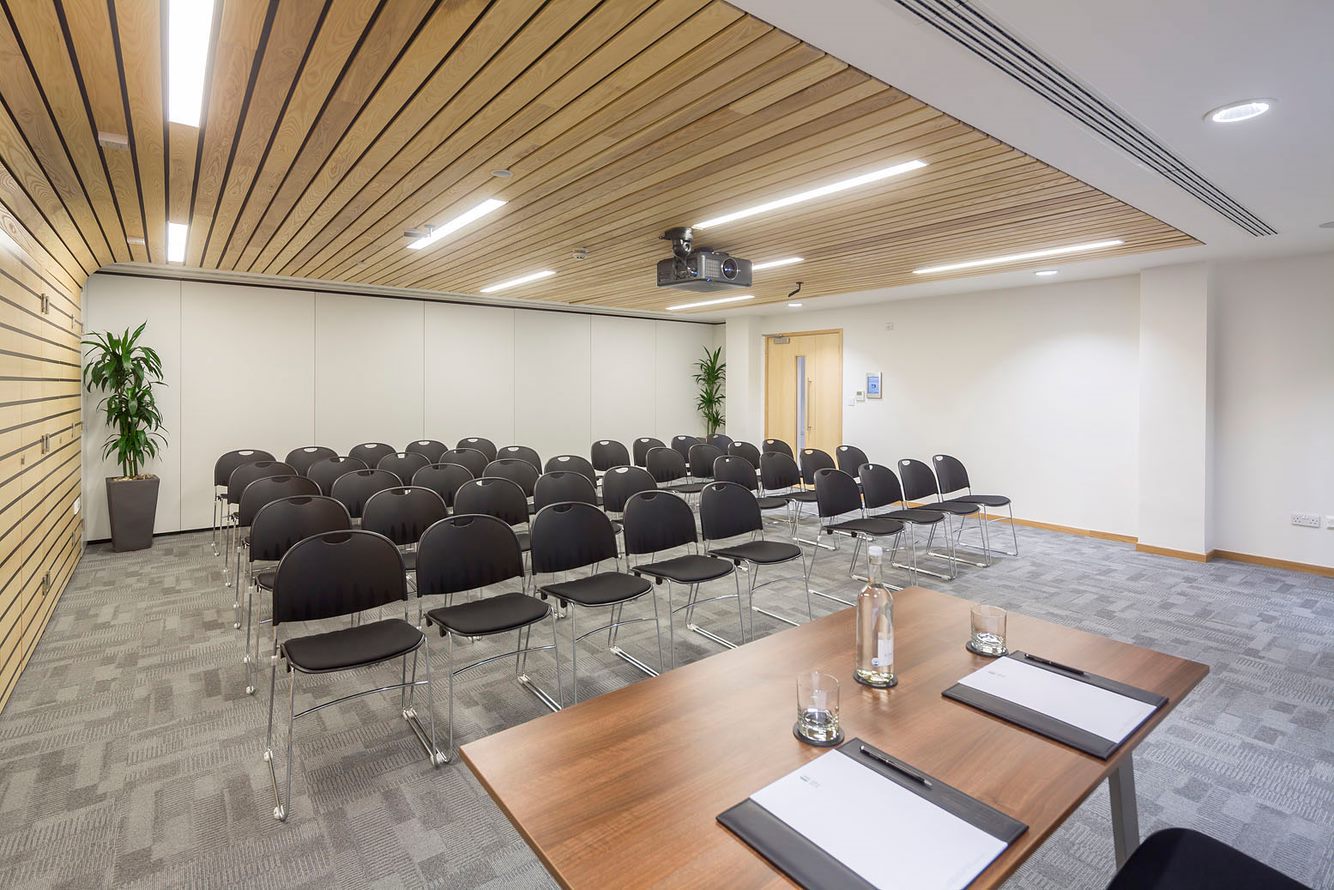 Seacole Room meeting space with wooden ceiling for presentations and workshops.