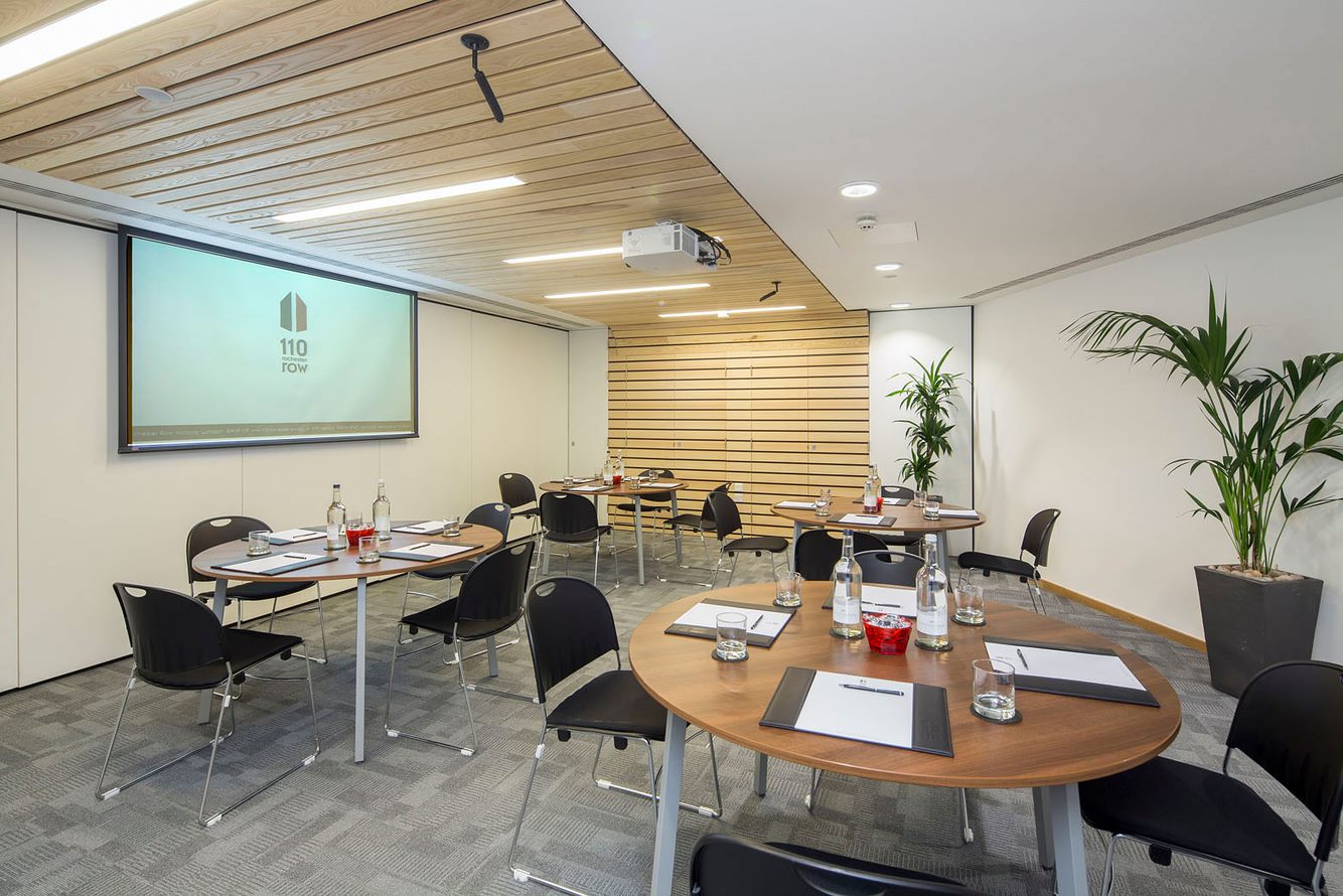 Cavell Room meeting space with round tables, ideal for productive events and presentations.