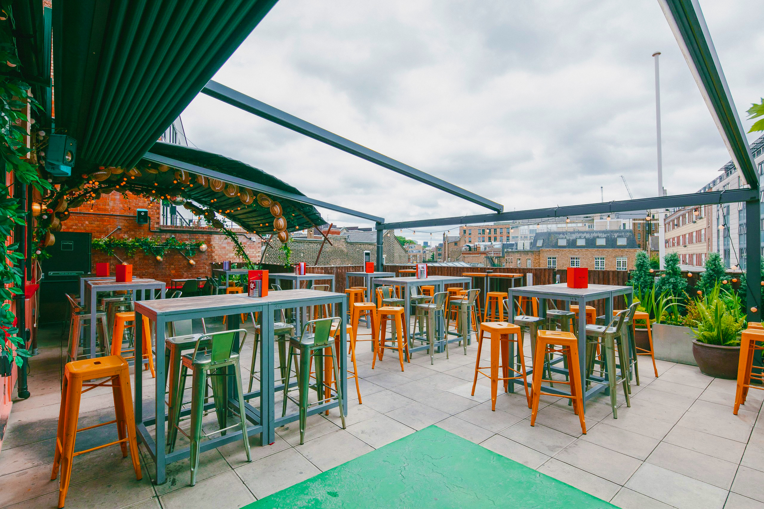 Stylish rooftop venue with modern tables, ideal for networking events and social gatherings.