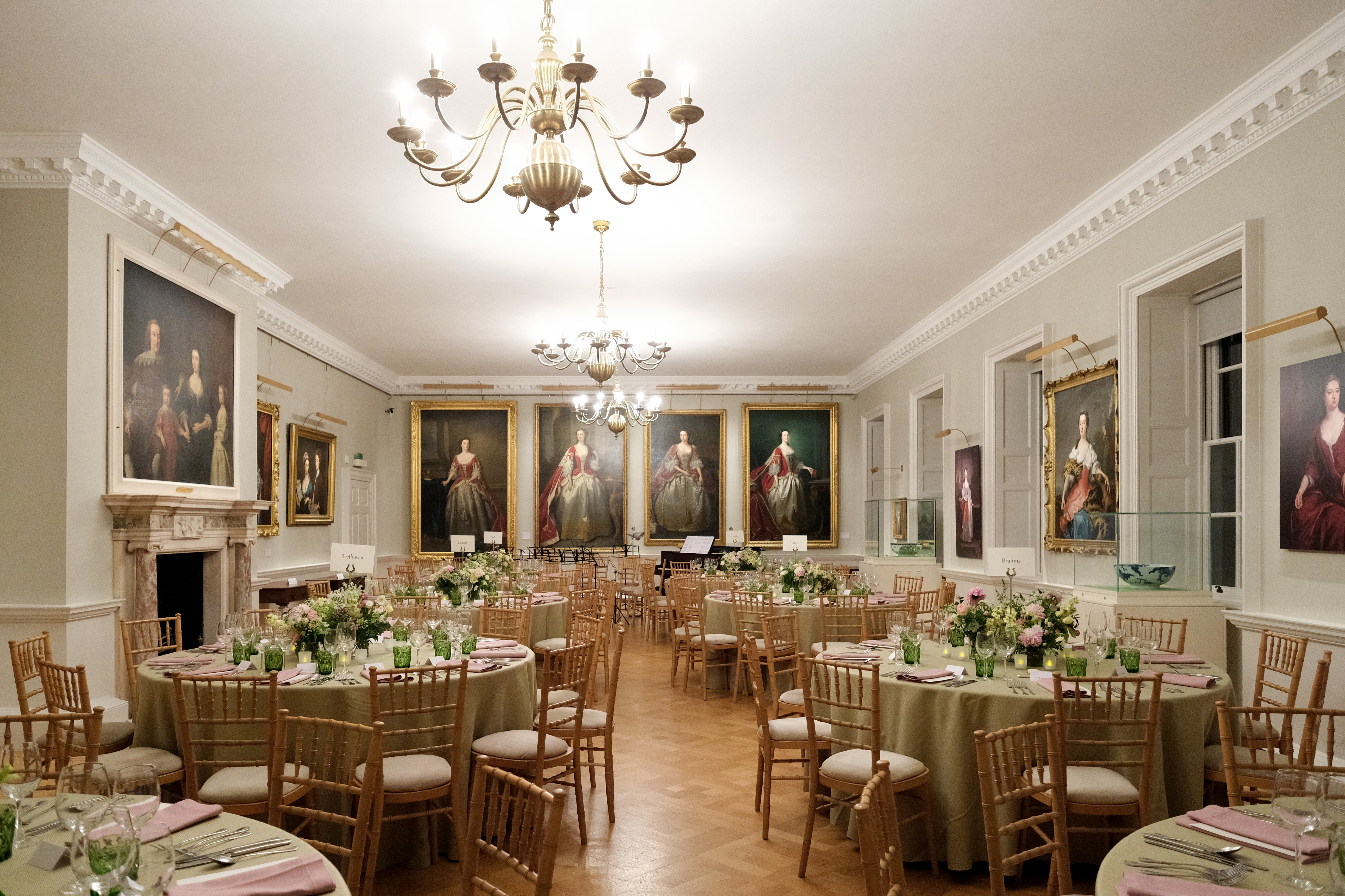 Elegant dining room with floral centerpieces for upscale events at The Foundling Museum.