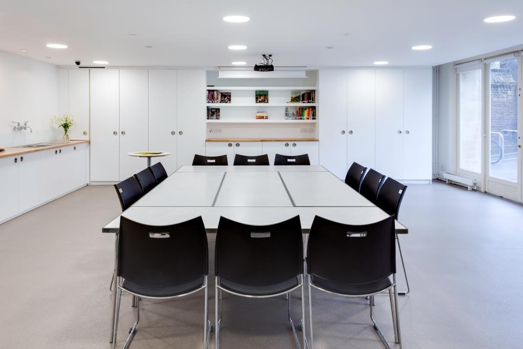 Modern meeting room at Clore Creative Studio, featuring a large table for workshops.