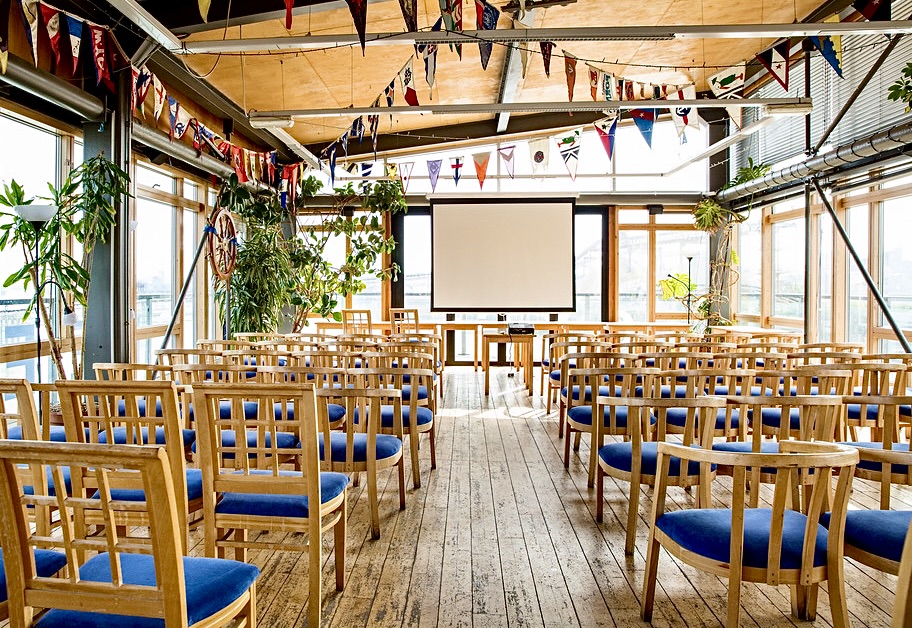 Event space at Greenwich Yacht Club with wooden chairs, ideal for workshops and seminars.
