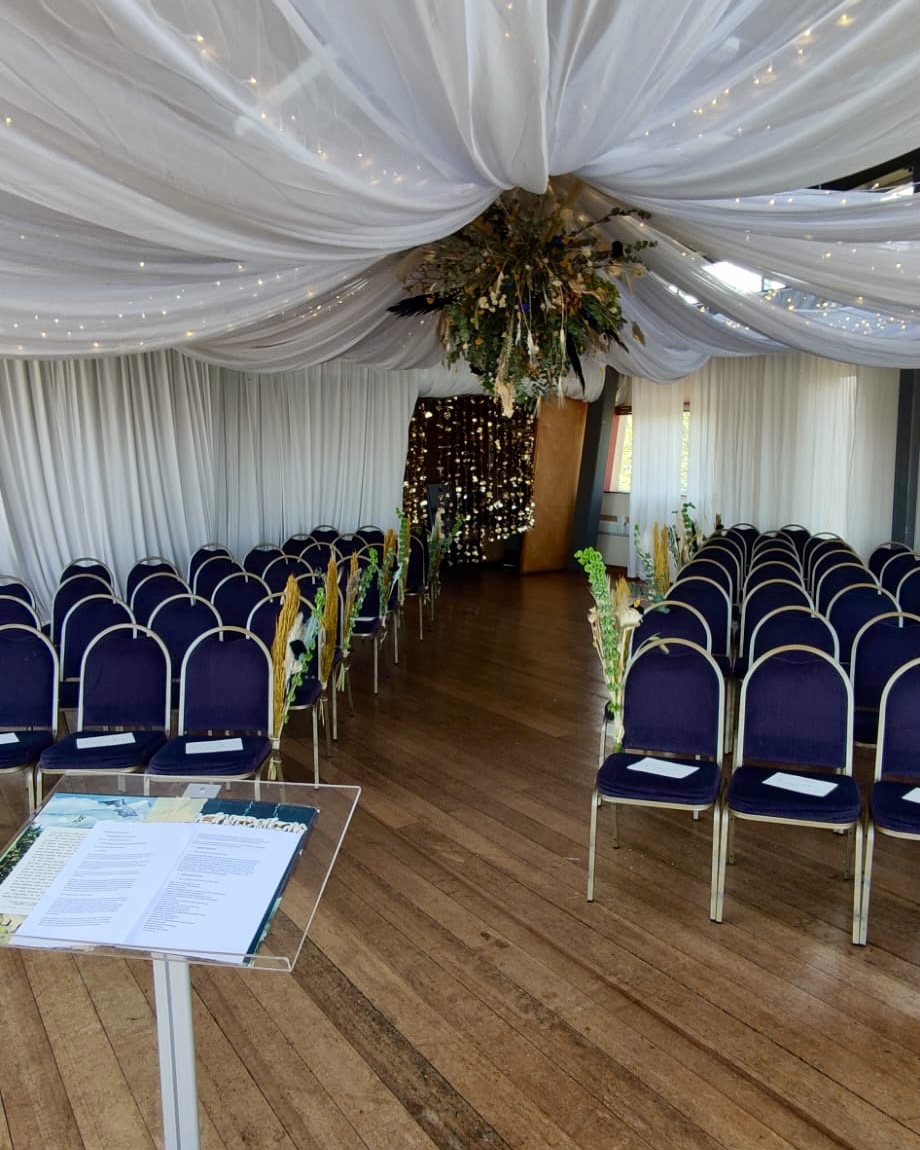 Elegant event space at Greenwich Yacht Club with floral accents for ceremonies and presentations.