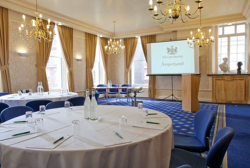 Meeting room at 113 Chancery Lane with round tables for corporate events and presentations.