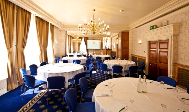 Elegant meeting room with round tables, ideal for corporate events and conferences.