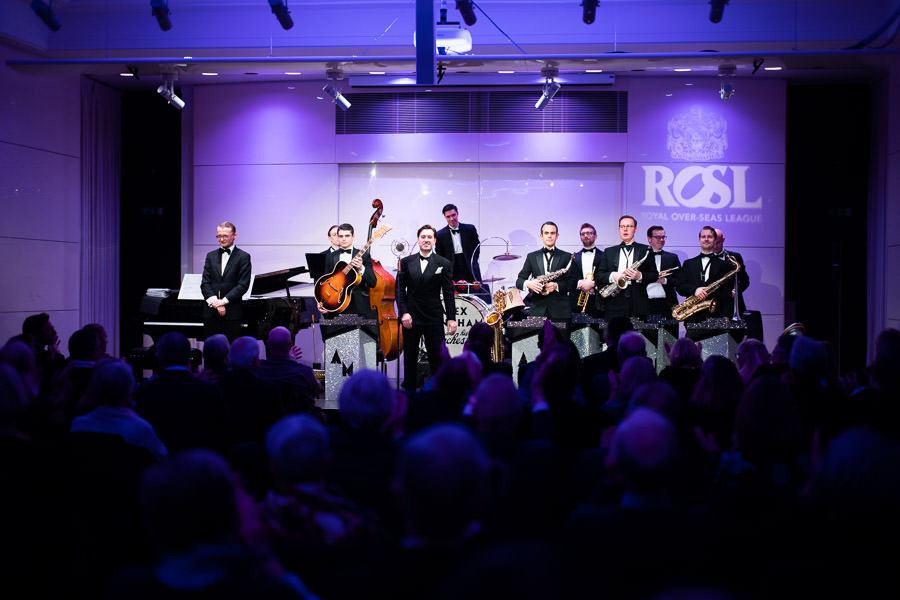 Live band performing in elegant Princess Alexandra Hall, perfect for corporate events.