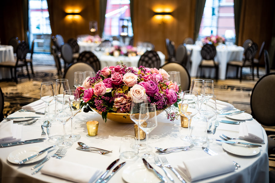 Elegant dining table with floral centerpiece for high-end events at Hall of India.