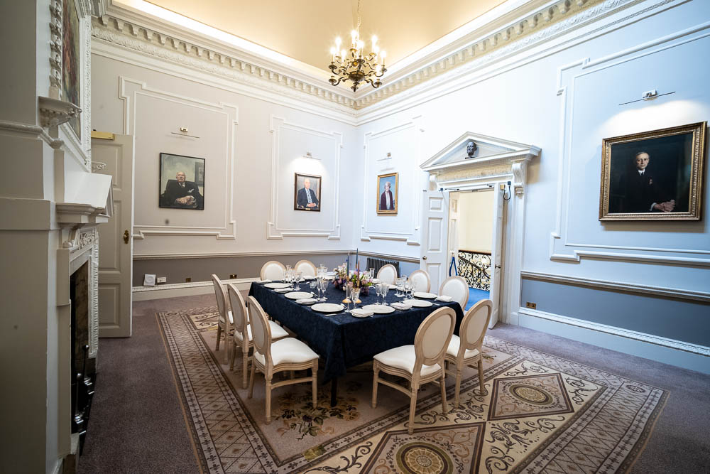 Sophisticated Wrench Room with elegant table setup for exclusive meetings and events.