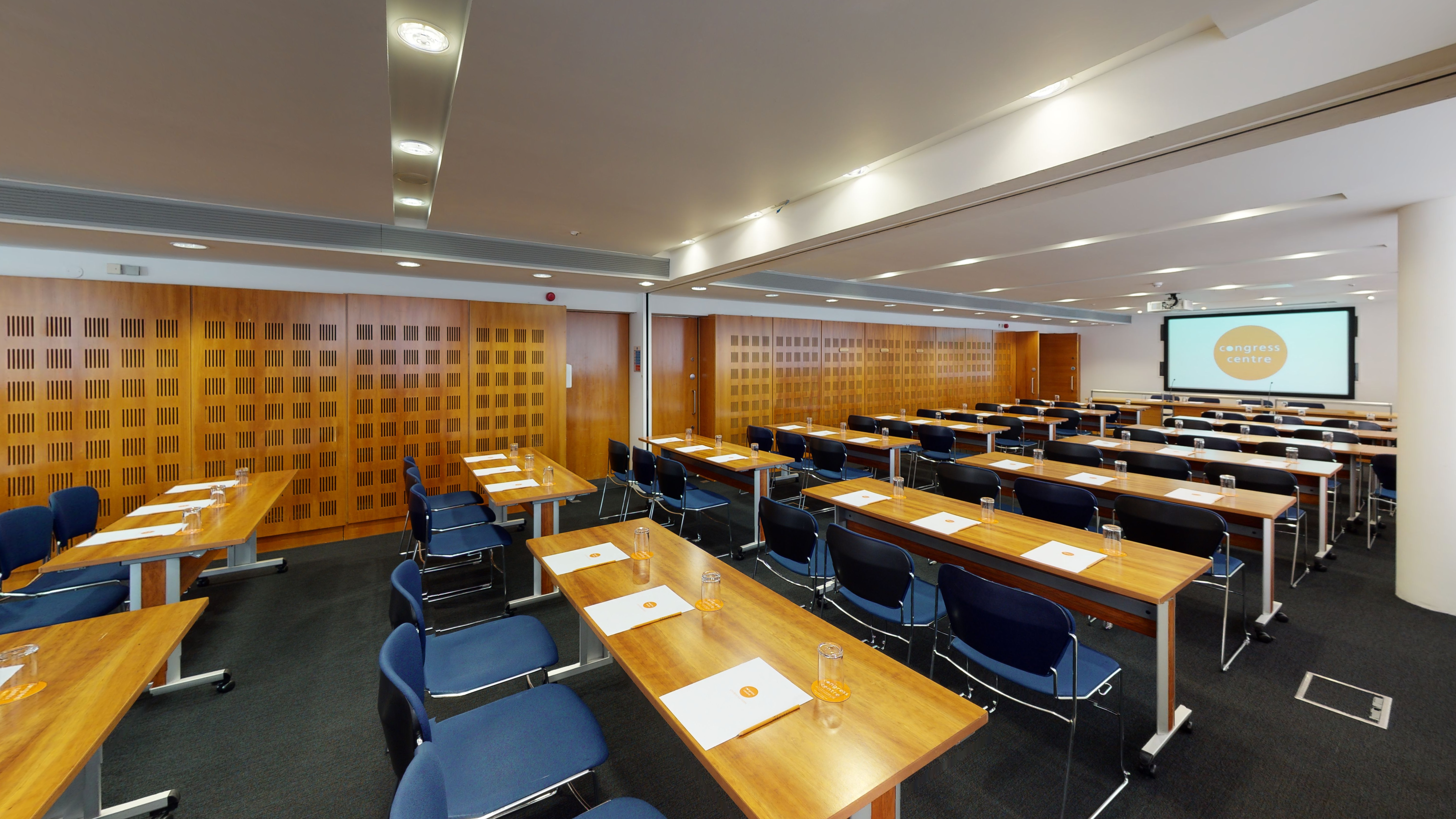 Invision Suite 4 meeting room with tables, chairs, and natural light for professional events.