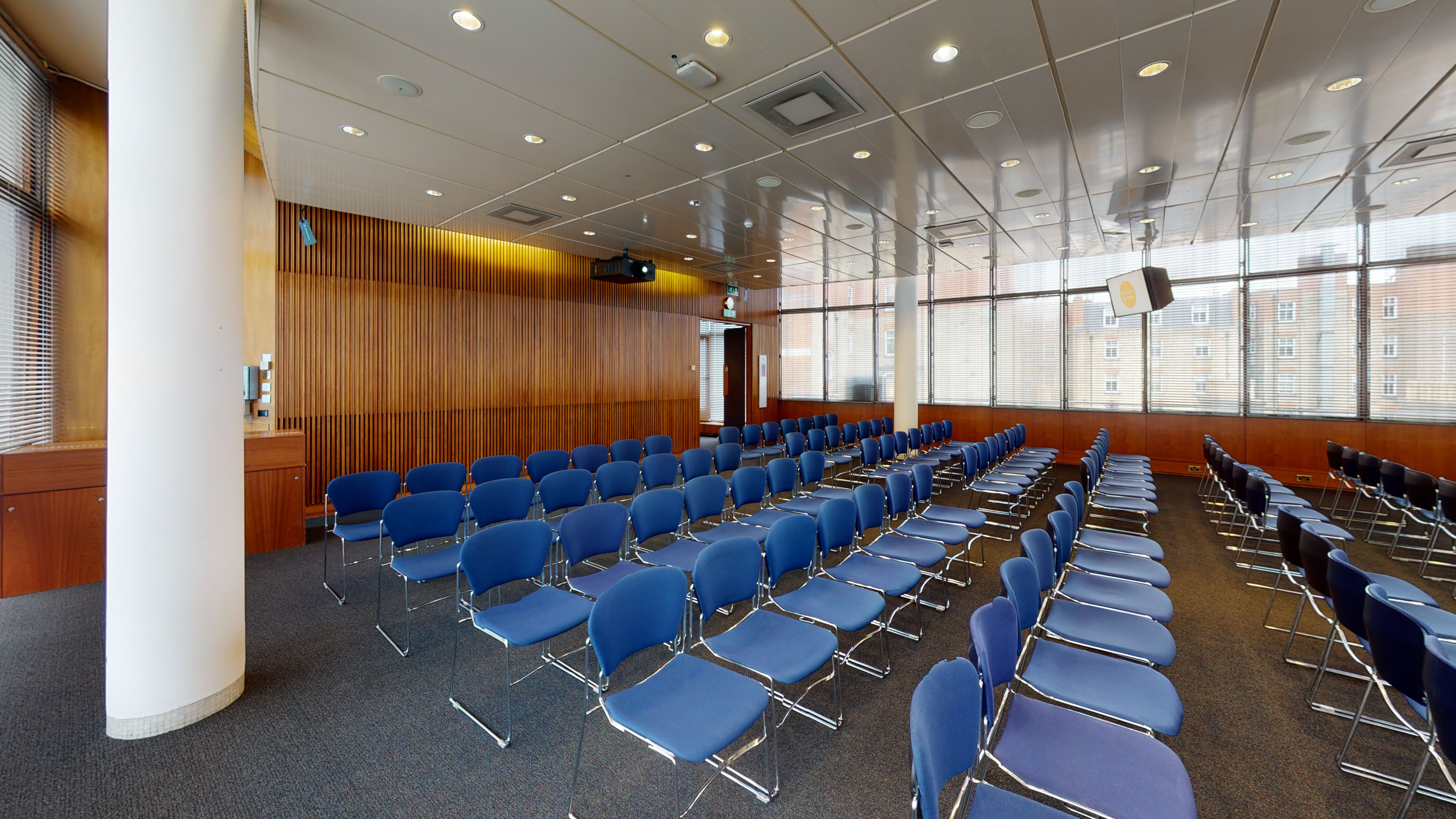 Council Chamber in Congress Centre with blue chairs, ideal for seminars and presentations.