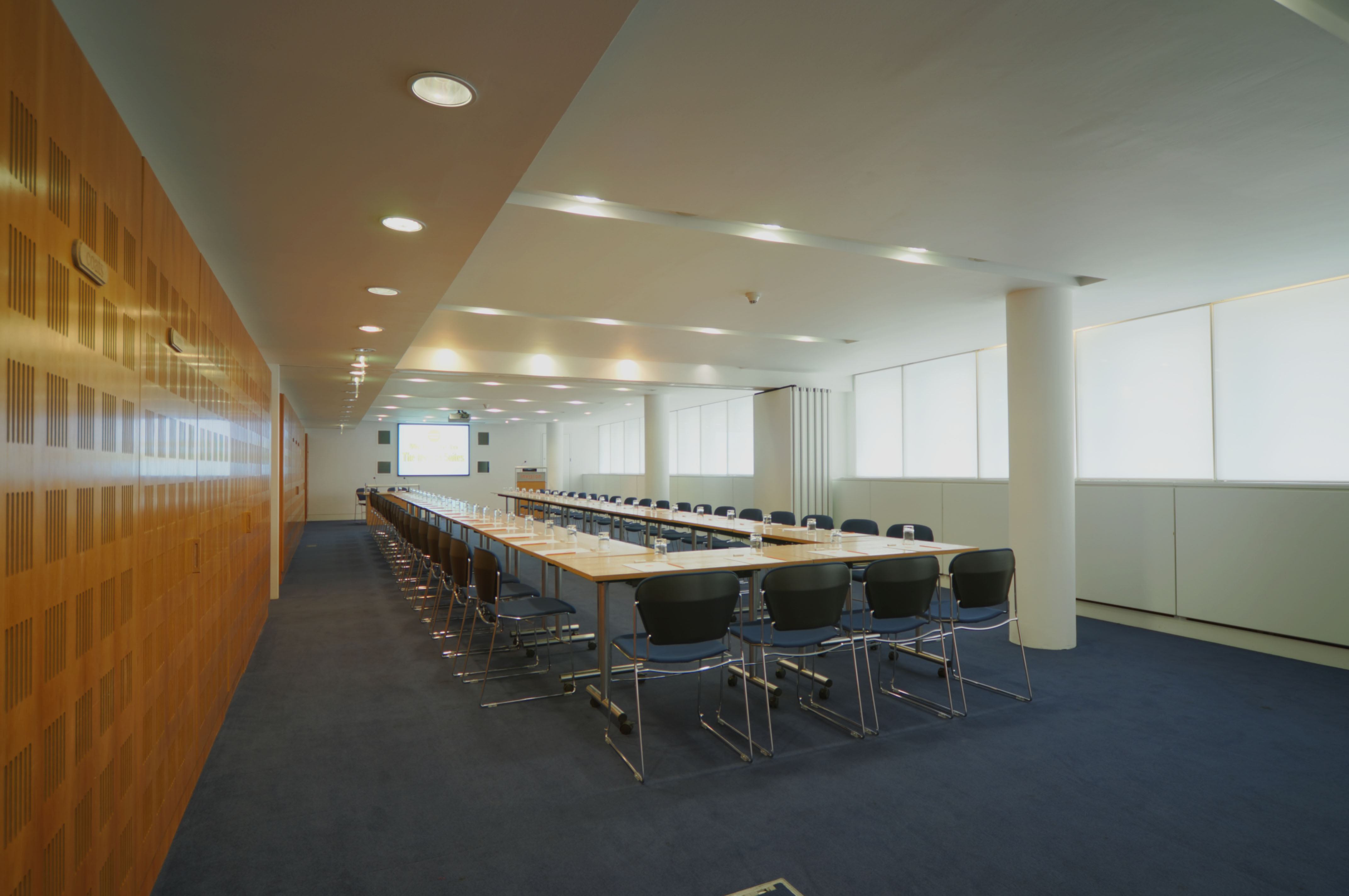 Modern conference room with long table, ideal for corporate meetings and presentations.
