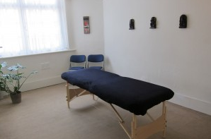 Serene therapy room with massage table for wellness events and relaxation sessions.
