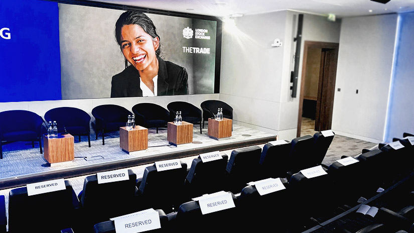 London Stock Exchange event space with sleek stage and reserved seating for presentations.