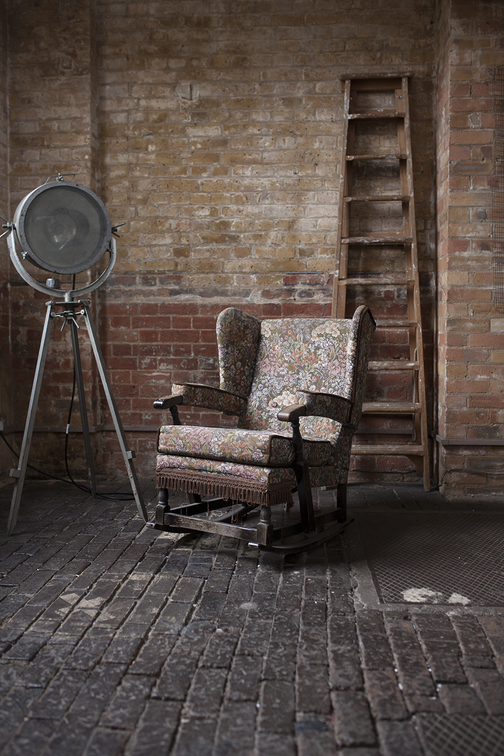 Vintage armchair in rustic studio, ideal for intimate gatherings and creative events.