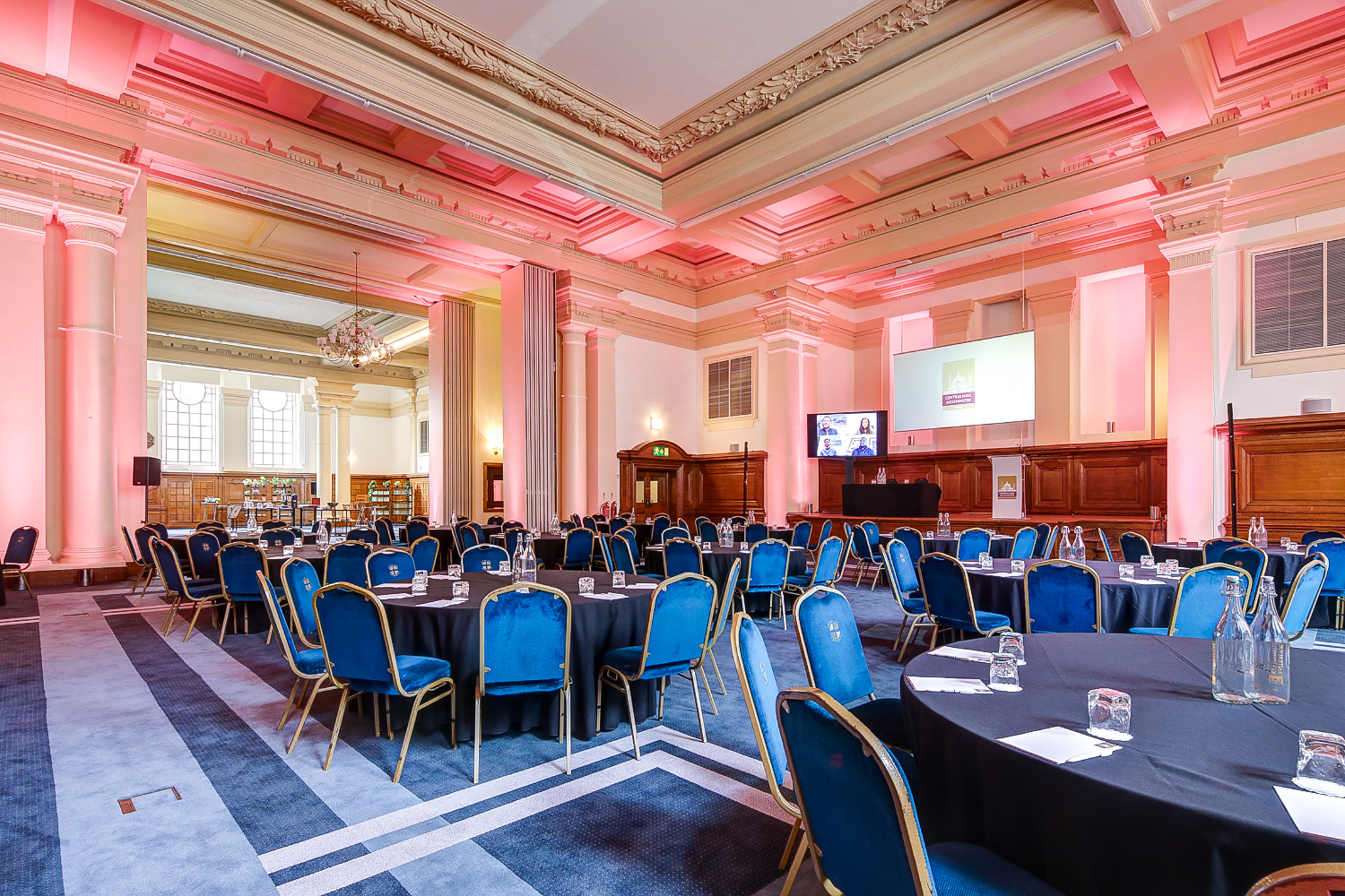 Elegant lecture hall with round tables, ideal for conferences and banquets.