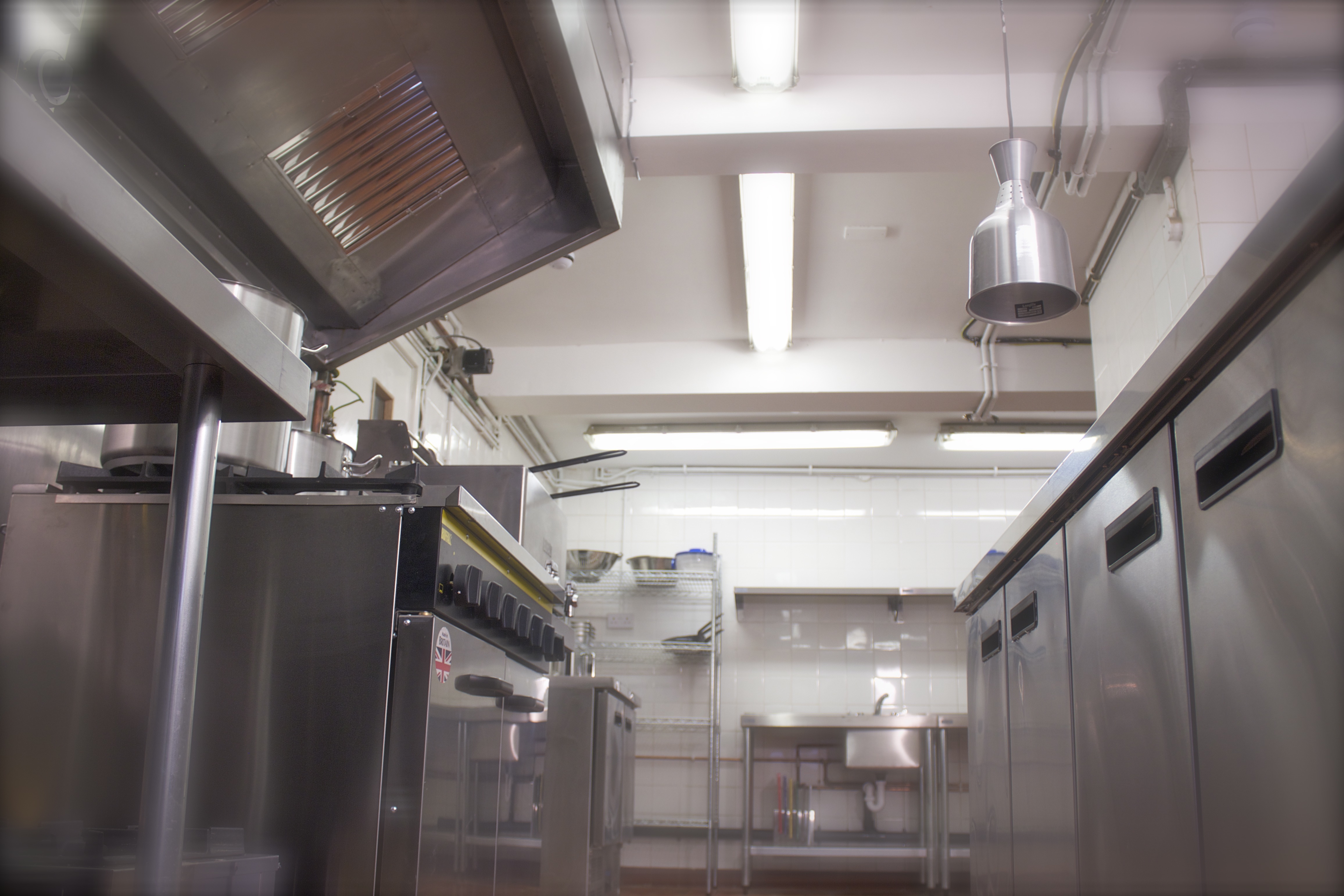 Professional kitchen in Maida Hill Place with stainless steel appliances for catering events.