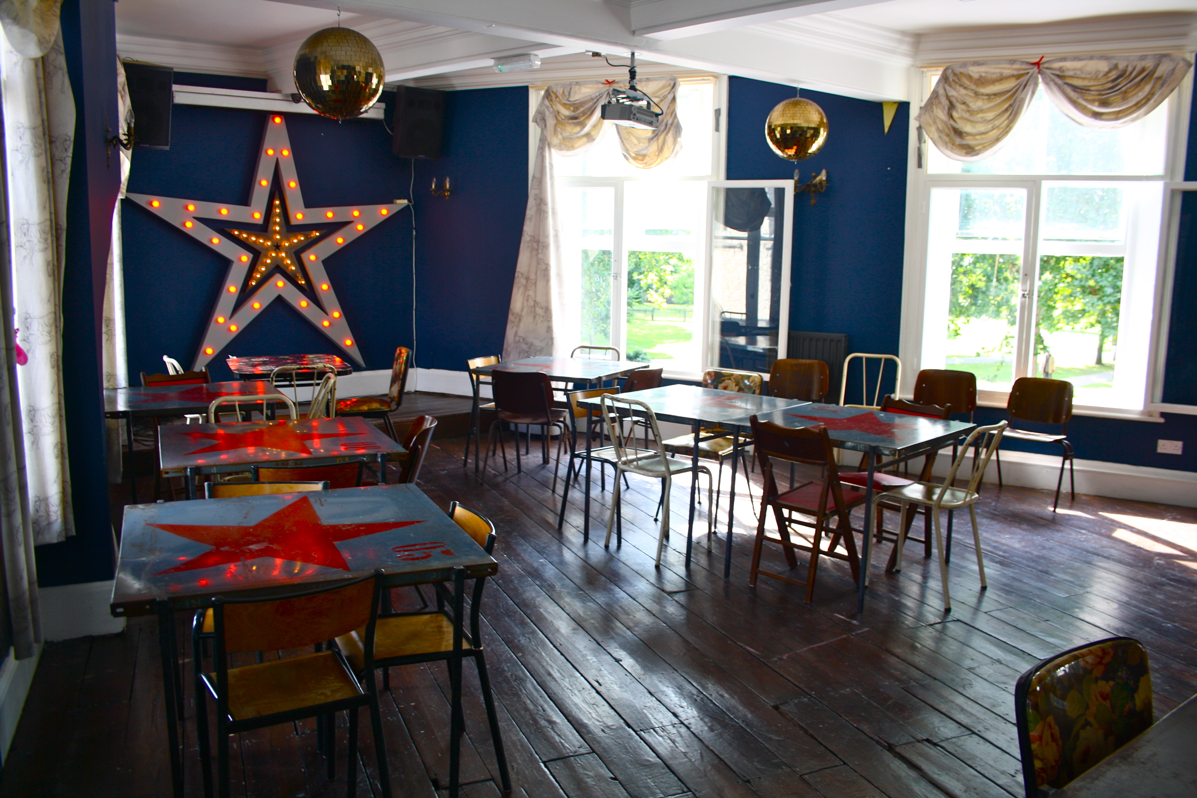 Upstairs Function Room at Star by Hackney Downs with star backdrop for creative events.