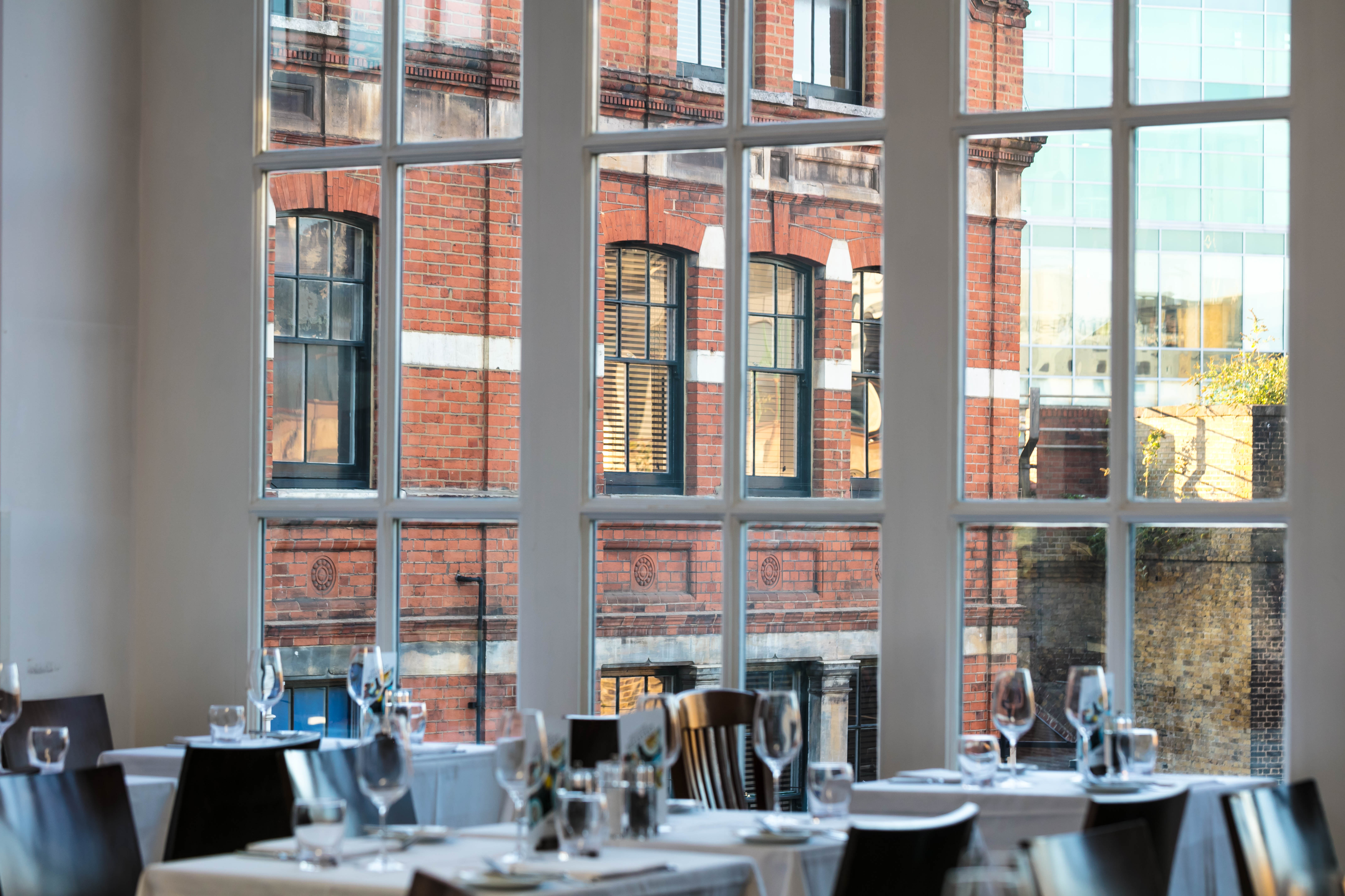 Stylish dining venue with large windows, ideal for upscale events and gatherings.
