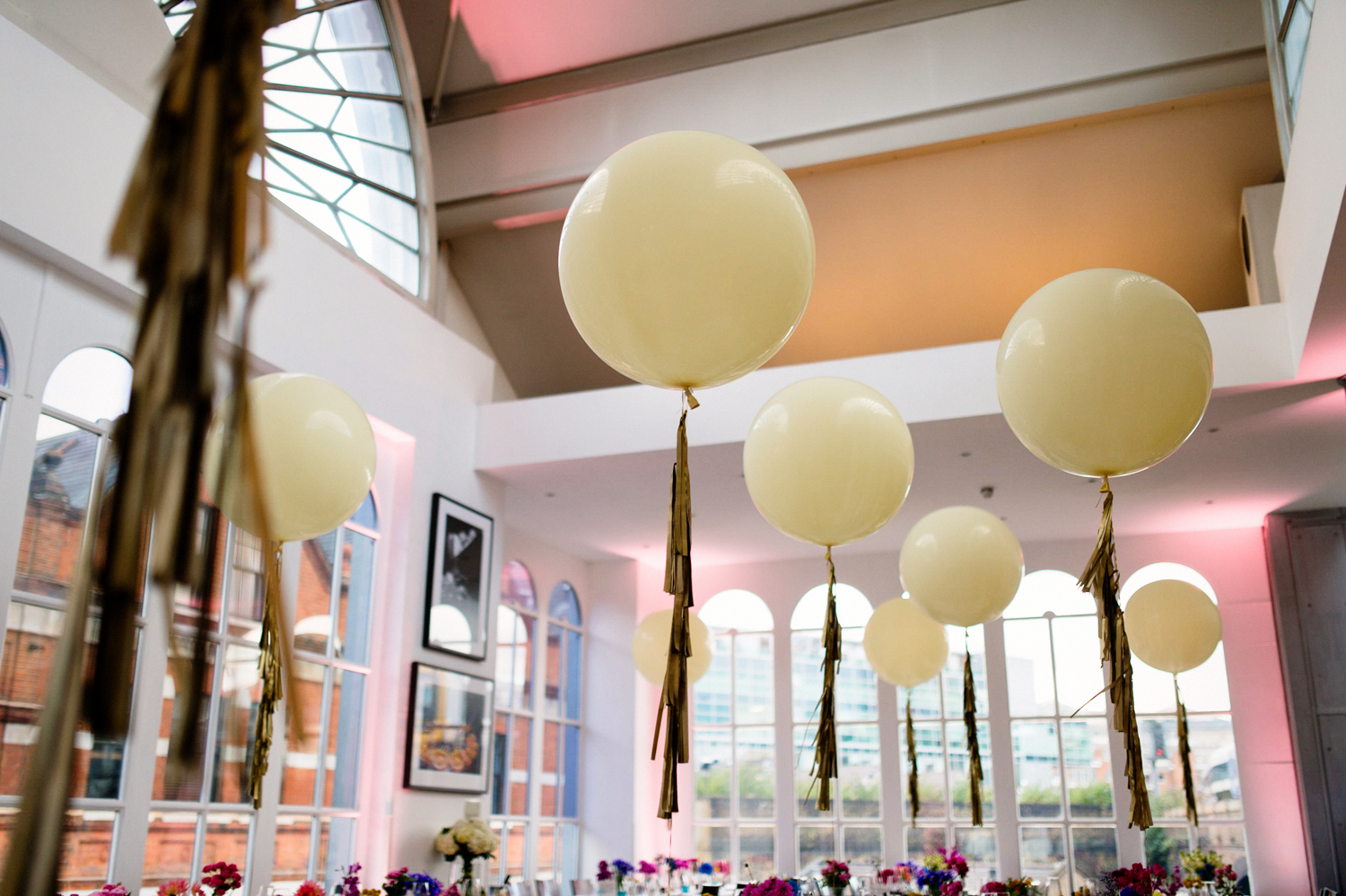 Elegant event space with cream balloons, perfect for weddings and corporate gatherings.