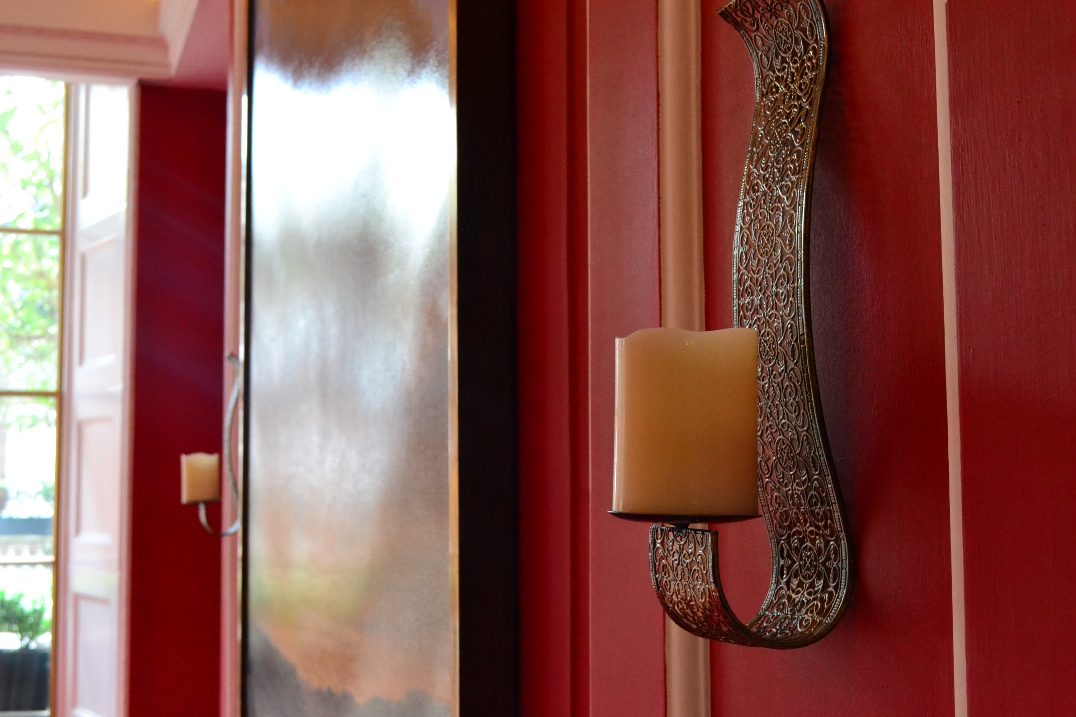 Elegant Ruby Salon interior with candle sconce, ideal for upscale events and gatherings.