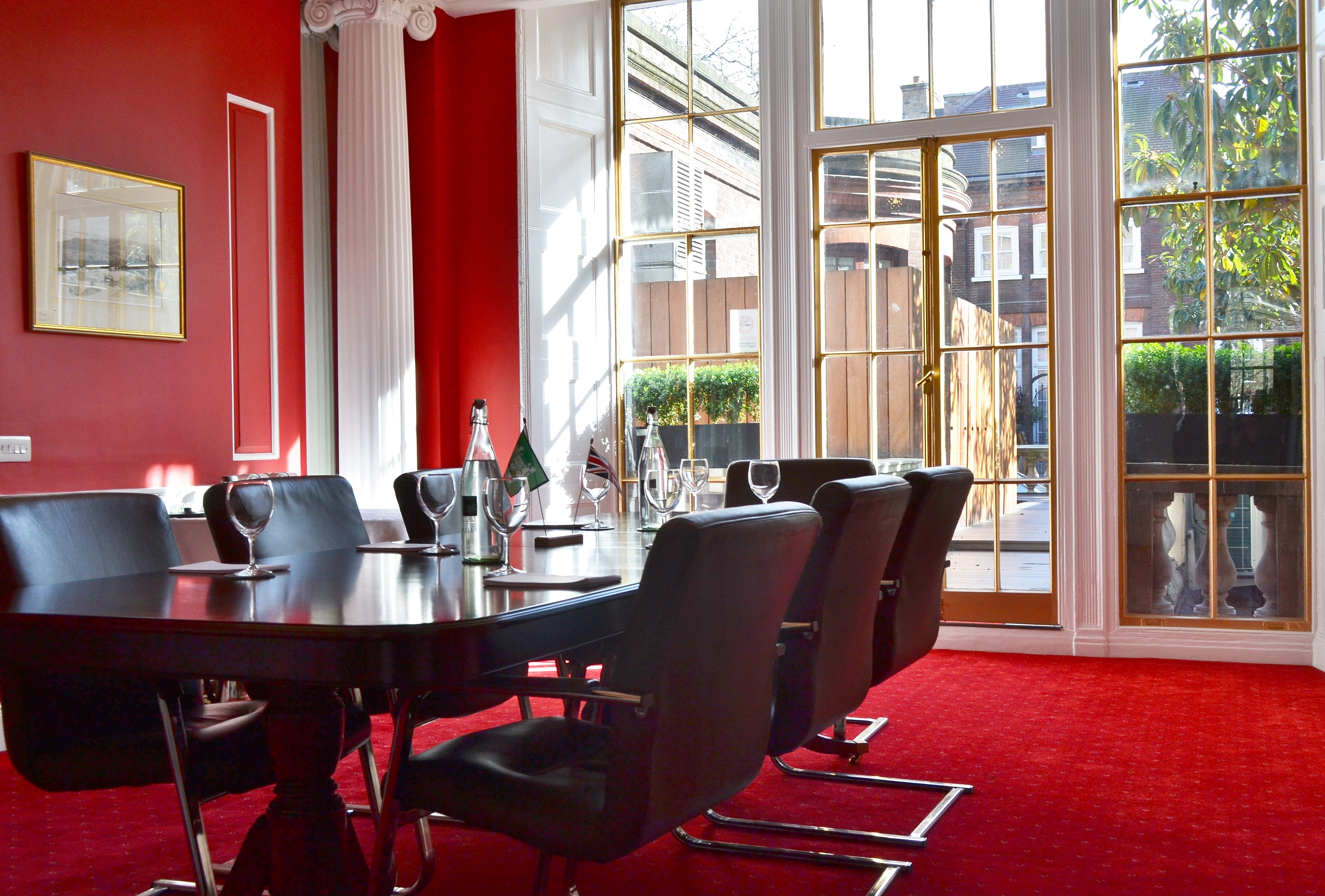 Ruby Salon meeting room with wooden table, ideal for corporate events and brainstorming.