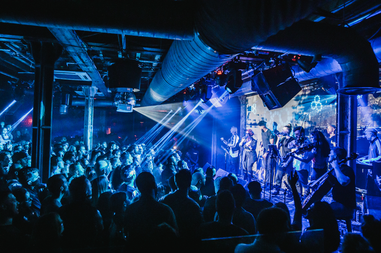 Vibrant live music event at XOYO, featuring dynamic lighting and energetic crowd.