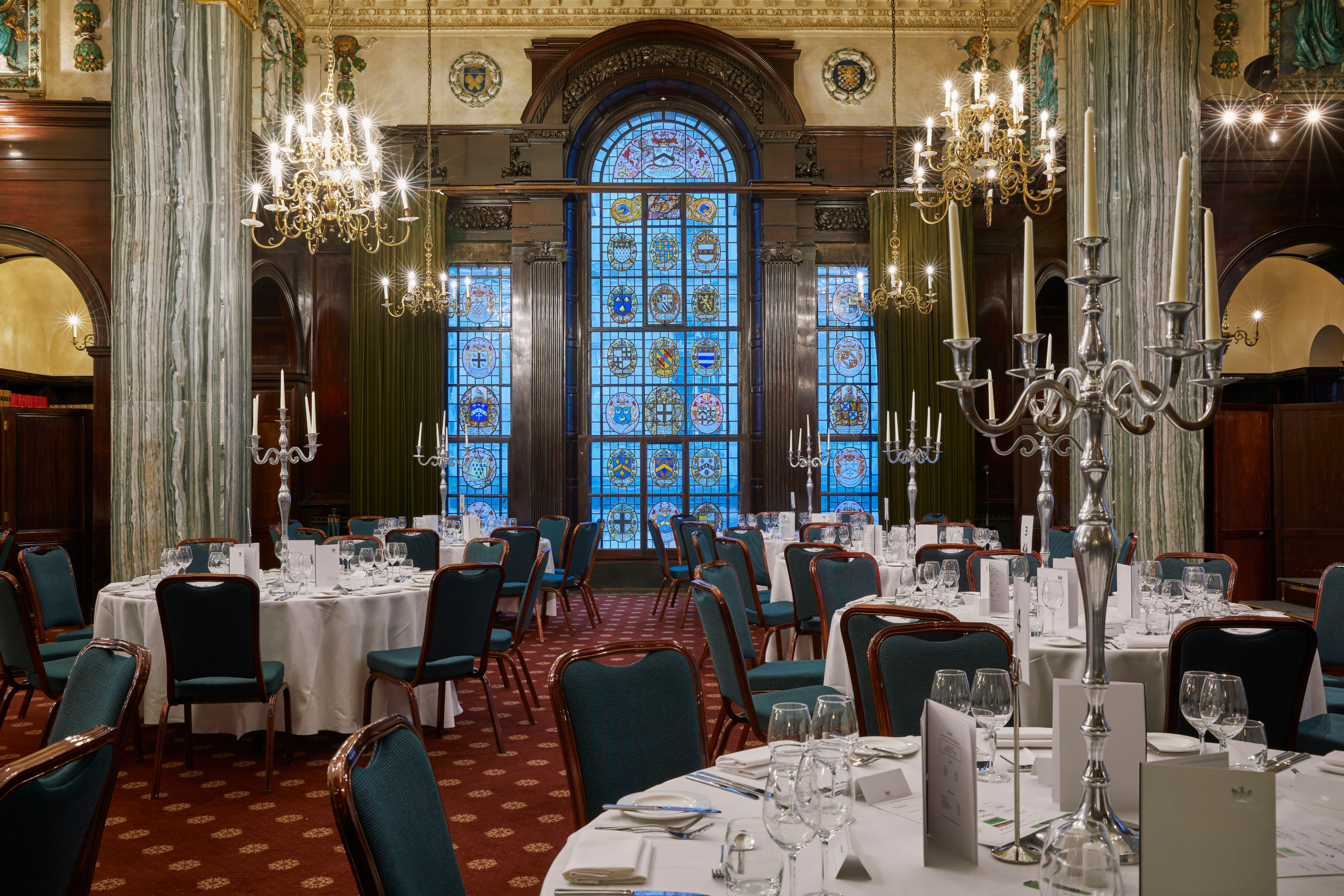 Elegant event space with stained glass, perfect for formal dinners and corporate events.