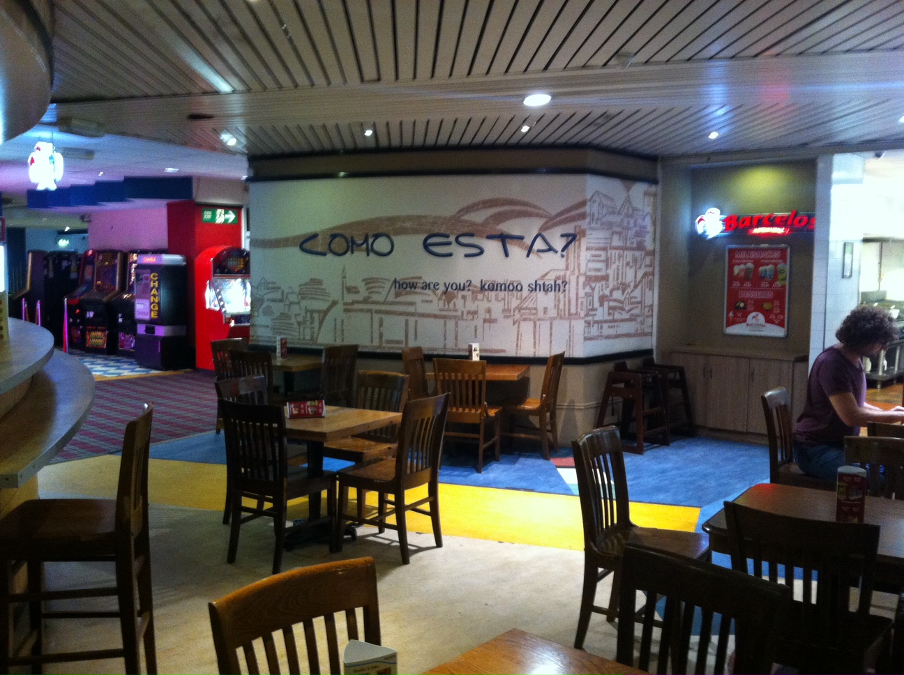 Bowling lanes at Airport Bowl, featuring wooden tables for casual networking events.