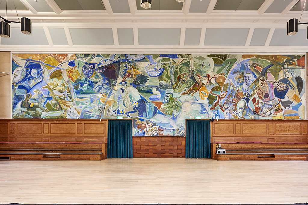 Kennedy Hall at Cecil Sharp House, spacious venue with vibrant mural for events.