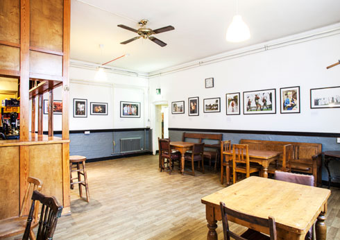 Rustic event space at Cecil Sharp House with wooden tables, ideal for workshops and receptions.